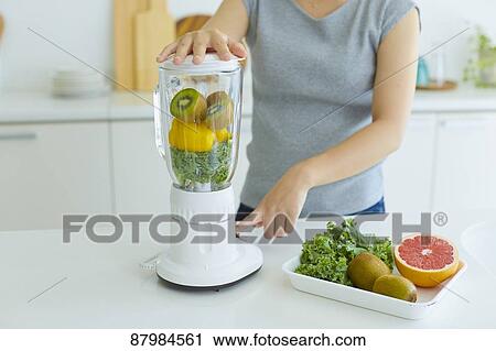 Japanese woman making smoothie in the kitchen View Large Photo Image Stock Image - Japanese woman making smoothie in the kitchen. Fotosearch