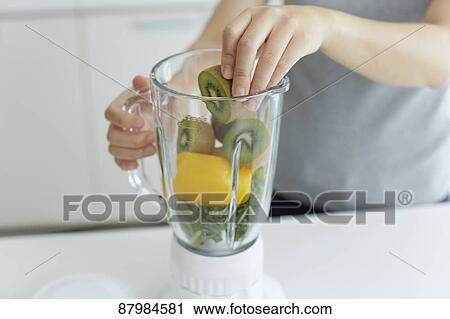 Japanese woman making smoothie in the kitchen View Large Photo Image Stock Image - Japanese woman making smoothie in the kitchen. Fotosearch