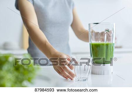 Japanese woman making smoothie in the kitchen View Large Photo Image Stock Image - Japanese woman making smoothie in the kitchen. Fotosearch