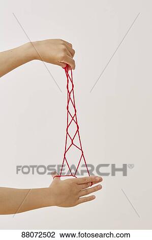 Japanese woman playing with red string View Large Photo Image Stock Image - Japanese woman playing with red string. Fotosearch