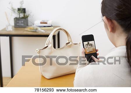 Stock Image - Japanese woman selling online. Fotosearch