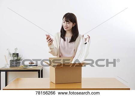 Stock Photograph - Japanese woman selling online. Fotosearch