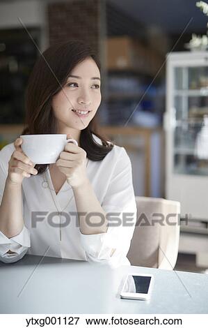 Stock Photo - Japanese woman stylish cafe. Fotosearch