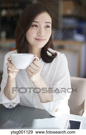 Stock Photo - Japanese woman stylish cafe. Fotosearch