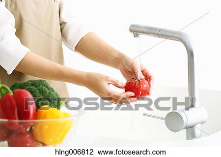 Japanese woman washing vegetables in the kitchen View Large Photo Image Stock Image - Japanese woman washing vegetables in the kitchen. Fotosearch