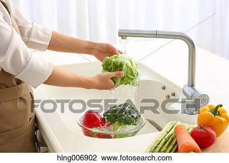 Japanese woman washing vegetables in the kitchen View Large Photo Image Stock Image - Japanese woman washing vegetables in the kitchen. Fotosearch
