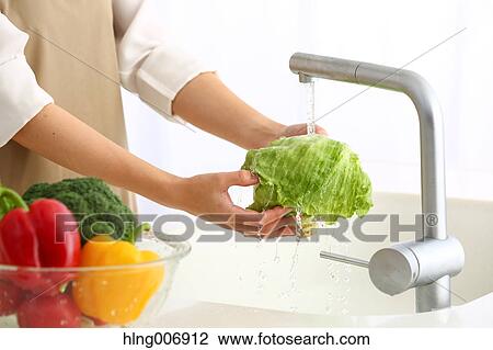 Japanese woman washing vegetables in the kitchen View Large Photo Image Stock Image - Japanese woman washing vegetables in the kitchen. Fotosearch