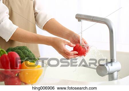Japanese woman washing vegetables in the kitchen View Large Photo Image Stock Photograph - Japanese woman washing vegetables in the kitchen. Fotosearch