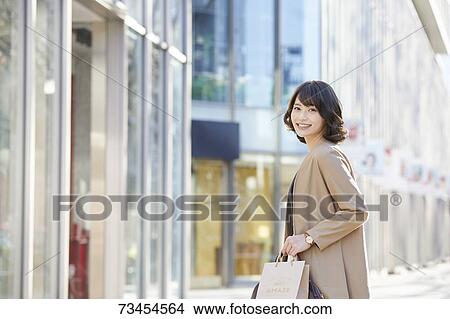 Japanese woman window shopping downtown Tokyo View Large Photo Image Picture - Japanese woman window shopping downtown Tokyo. Fotosearch