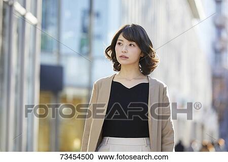 Japanese woman window shopping downtown Tokyo View Large Photo Image Stock Image - Japanese woman window shopping downtown Tokyo. Fotosearch