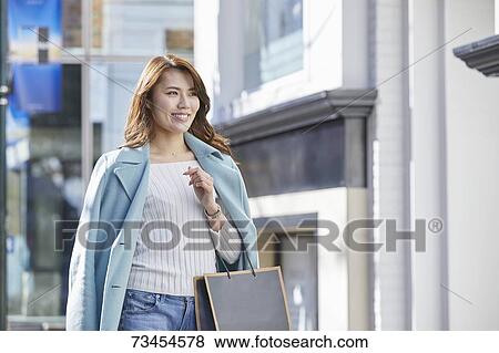Japanese woman window shopping downtown Tokyo View Large Photo Image Stock Photo - Japanese woman window shopping downtown Tokyo. Fotosearch