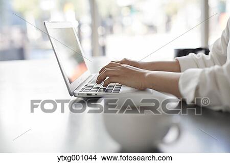 Japanese woman with laptop in a stylish cafe View Large Photo Image Picture - Japanese woman with laptop in a stylish cafe. Fotosearch