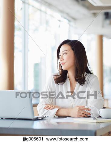 Japanese woman with laptop in a stylish cafe View Large Photo Image Stock Image - Japanese woman with laptop in a stylish cafe. Fotosearch