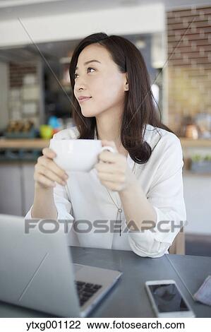 Japanese woman with laptop in a stylish cafe View Large Photo Image Stock Image - Japanese woman with laptop in a stylish cafe. Fotosearch