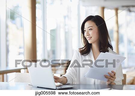 Japanese woman with laptop in a stylish cafe View Large Photo Image Stock Photo - Japanese woman with laptop in a stylish cafe. Fotosearch