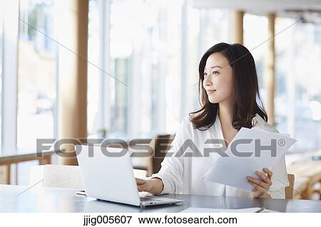 Japanese woman with laptop in a stylish cafe View Large Photo Image Stock Photo - Japanese woman with laptop in a stylish cafe. Fotosearch