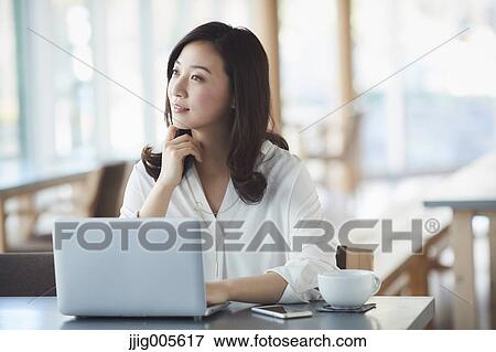 Japanese woman with laptop in a stylish cafe View Large Photo Image Stock Photo - Japanese woman with laptop in a stylish cafe. Fotosearch