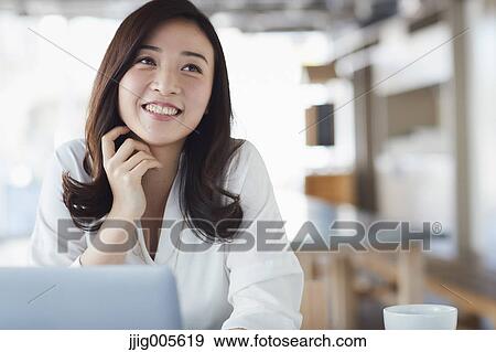 Japanese woman with laptop in a stylish cafe View Large Photo Image Stock Photo - Japanese woman with laptop in a stylish cafe. Fotosearch