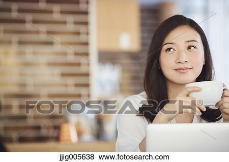 Japanese woman with laptop in a stylish cafe View Large Photo Image Stock Photo - Japanese woman with laptop in a stylish cafe. Fotosearch