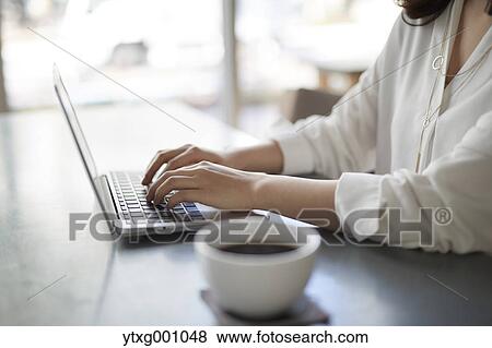Japanese woman with laptop in a stylish cafe View Large Photo Image Stock Photo - Japanese woman with laptop in a stylish cafe. Fotosearch