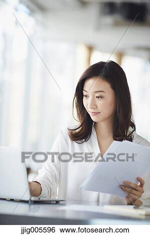 Japanese woman with laptop in a stylish cafe View Large Photo Image Stock Photograph - Japanese woman with laptop in a stylish cafe. Fotosearch