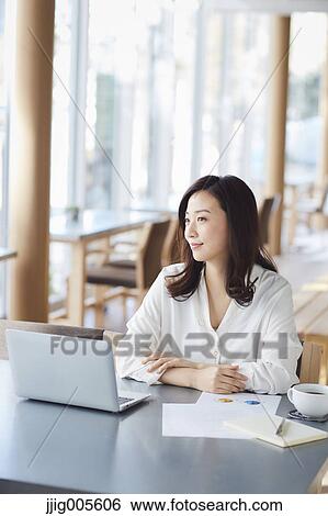 Japanese woman with laptop in a stylish cafe View Large Photo Image Stock Photograph - Japanese woman with laptop in a stylish cafe. Fotosearch