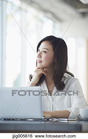 Japanese woman with laptop in a stylish cafe View Large Photo Image Stock Photograph - Japanese woman with laptop in a stylish cafe. Fotosearch