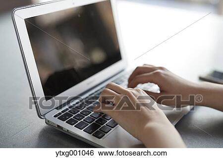 Japanese woman with laptop in a stylish cafe View Large Photo Image Stock Photograph - Japanese woman with laptop in a stylish cafe. Fotosearch