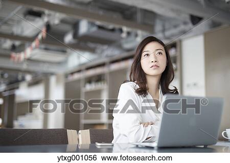 Japanese woman with laptop in a stylish cafe View Large Photo Image Stock Photograph - Japanese woman with laptop in a stylish cafe. Fotosearch
