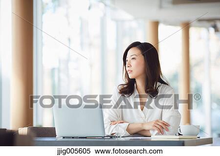 Japanese woman with laptop in a stylish cafe View Large Photo Image Stock Photography - Japanese woman with laptop in a stylish cafe. Fotosearch