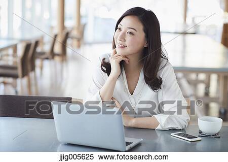 Japanese woman with laptop in a stylish cafe View Large Photo Image Stock Photography - Japanese woman with laptop in a stylish cafe. Fotosearch