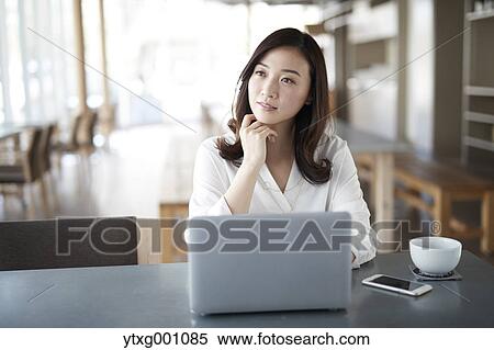 Japanese woman with laptop in a stylish cafe View Large Photo Image Stock Photography - Japanese woman with laptop in a stylish cafe. Fotosearch