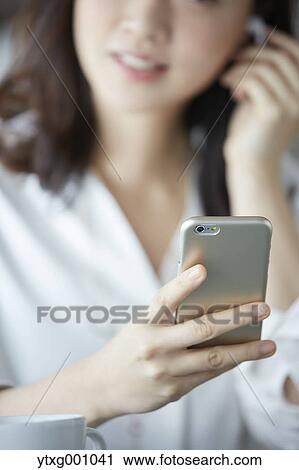 Japanese woman with smartphone in a stylish cafe View Large Photo Image Stock Image - Japanese woman with smartphone in a stylish cafe. Fotosearch