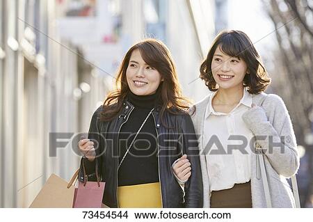 Japanese women window shopping downtown Tokyo View Large Photo Image Picture - Japanese women window shopping downtown Tokyo. Fotosearch