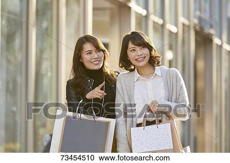 Japanese women window shopping downtown Tokyo View Large Photo Image Stock Image - Japanese women window shopping downtown Tokyo. Fotosearch