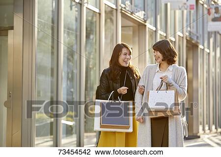 Japanese women window shopping downtown Tokyo View Large Photo Image Stock Image - Japanese women window shopping downtown Tokyo. Fotosearch
