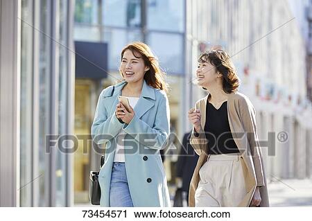 Japanese women window shopping downtown Tokyo View Large Photo Image Stock Image - Japanese women window shopping downtown Tokyo. Fotosearch