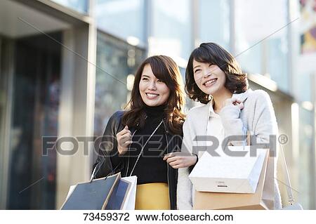 Japanese women window shopping downtown Tokyo View Large Photo Image Stock Image - Japanese women window shopping downtown Tokyo. Fotosearch