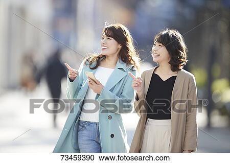 Japanese women window shopping downtown Tokyo View Large Photo Image Stock Image - Japanese women window shopping downtown Tokyo. Fotosearch