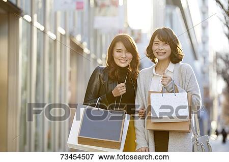 Japanese women window shopping downtown Tokyo View Large Photo Image Stock Photo - Japanese women window shopping downtown Tokyo. Fotosearch