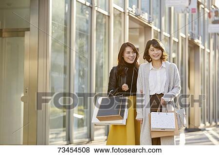 Japanese women window shopping downtown Tokyo View Large Photo Image Stock Photo - Japanese women window shopping downtown Tokyo. Fotosearch
