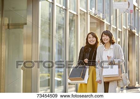 Japanese women window shopping downtown Tokyo View Large Photo Image Stock Photo - Japanese women window shopping downtown Tokyo. Fotosearch