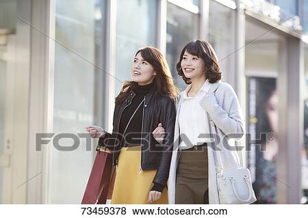 Japanese women window shopping downtown Tokyo View Large Photo Image Stock Photo - Japanese women window shopping downtown Tokyo. Fotosearch