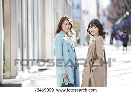 Stock Photo - Japanese women window shopping downtown Tokyo. Fotosearch