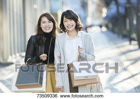 Japanese women window shopping downtown Tokyo View Large Photo Image Stock Photograph - Japanese women window shopping downtown Tokyo. Fotosearch