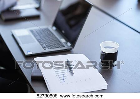 Laptop and paperwork on a wooden desk View Large Photo Image Stock Photo - Laptop and paperwork on a wooden desk. Fotosearch