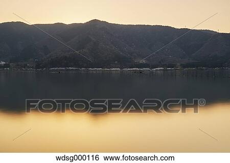 Stock Photograph - Long exposure of Lake Biwa at sunset, Shiga Prefecture, Japan. Fotosearch