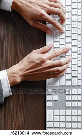 Picture - Male hands working on keyboard. Fotosearch