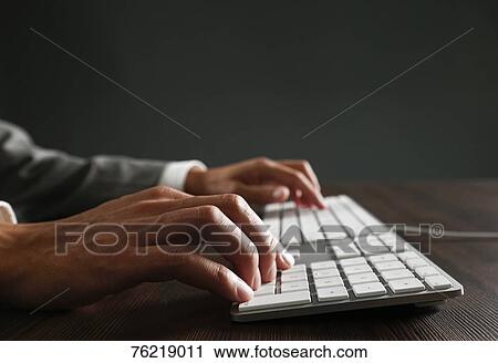 Stock Image - Male hands working on keyboard. Fotosearch