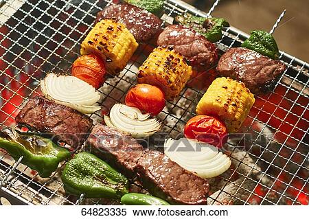 Meat skewers on grill View Large Photo Image Stock Photography - Meat skewers on grill. Fotosearch
